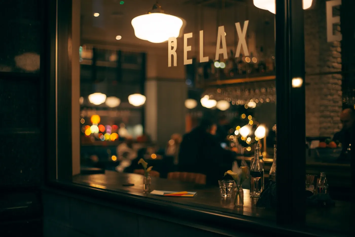 A restaurant counter with lights on in the evening.